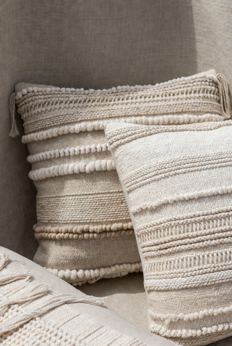 Textured throw pillows with natural fiber weaving